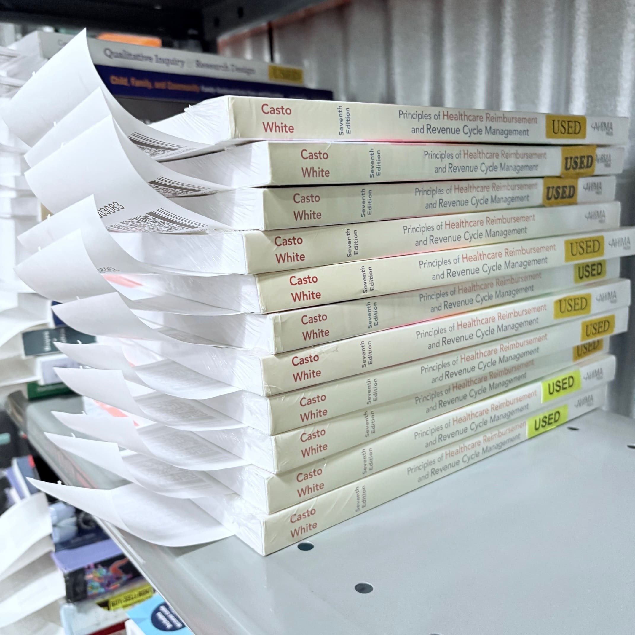 “Used textbooks sorted and labeled on warehouse shelves.”